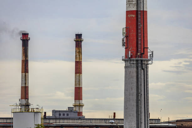 Heavy industry, air pollution, old brick chimney, releasing pollutants and water vapor into the atmosphere