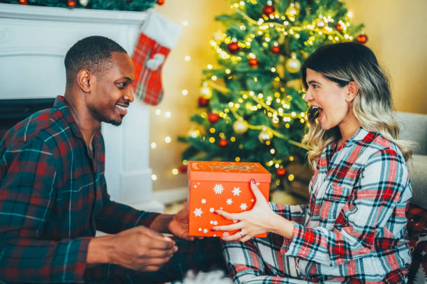 istock Young couple celebrating Christmas at home 2177072041