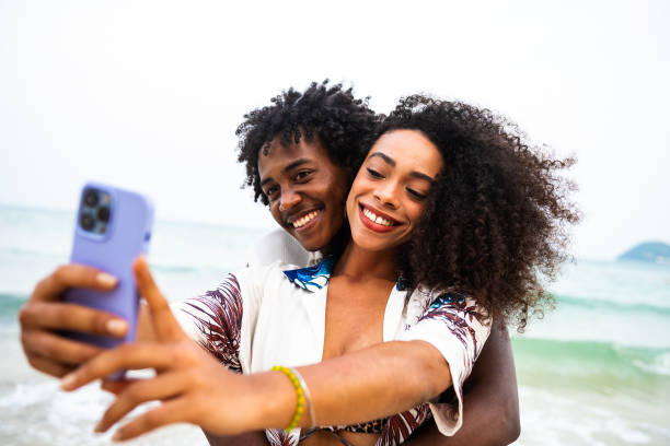 istock Joyful Afro couple taking a beachside selfie 2177072330