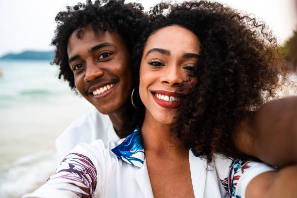 istock Afro couple's close-up selfie at the beach 2177072344