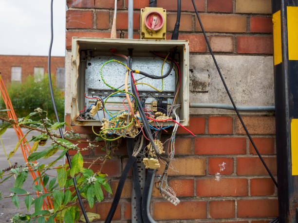 istock Exposed and tangled electrical wiring in an outdoor utility box on red brick wall. 2177075414
