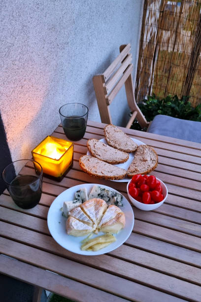 Cozy Evening Patio Dining with Cheese Board and Candlelight Ambiance