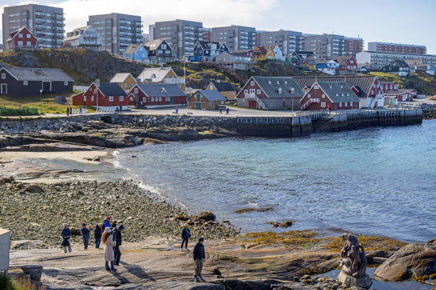 Nuuk, Godthåb, Greenland, Denmark - August 18th 2024:  View to the skyline of the modern Nuuk with a row of large residential buildings placed on the high bedrock