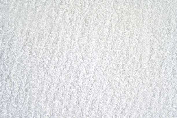 White shower towel texture. Fluffy carpet background. Blank bathroom textile. Warm sweater natural material. Soft baby fabric backdrop detail. Grey flat surface. Home canvas design