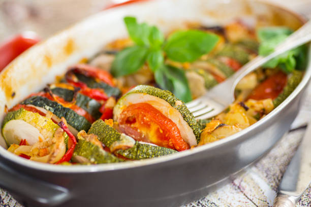 istock prepared baked zucchini and tomatoes in circles in a ceramic form, vegetable snack 2177084961