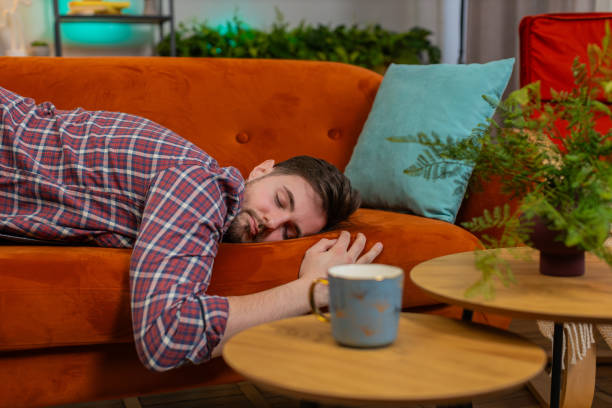 istock Exhausted young alcoholic drunk man flopped down on couch falls asleep after party tired overworked 2177086988