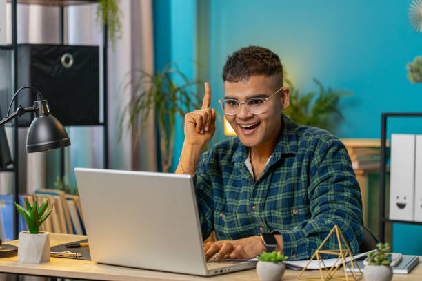 istock Inspired happy man make Eureka gesture raises finger came up with creative plan working on laptop 2177087076