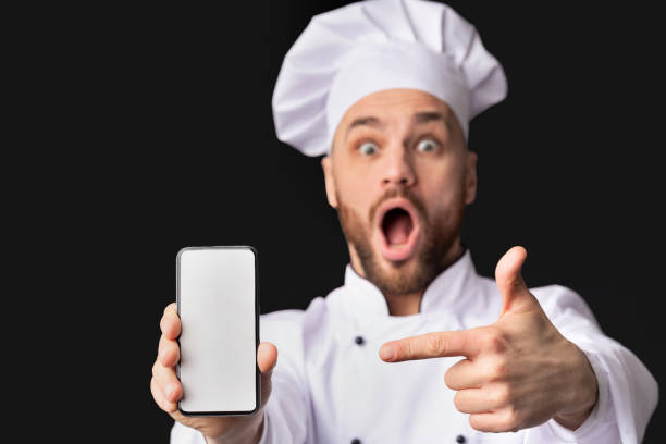 istock Chef Showing Phone Screen Recommending Application On Black Background, Mockup 2177089423
