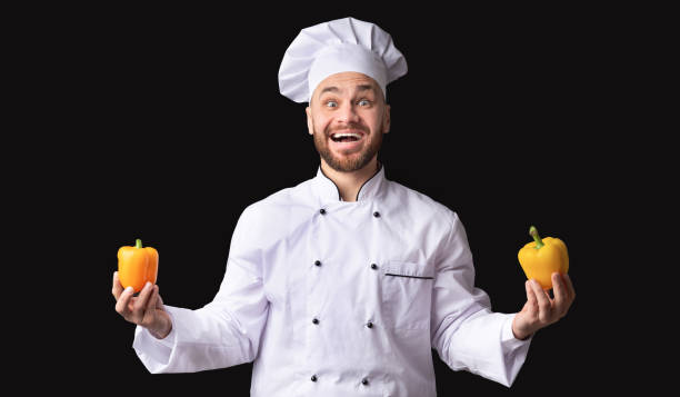 istock Excited Chef Man Holding Two Yellow Peppers Posing, Studio Shot 2177089442