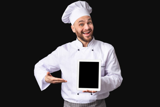 istock Excited Male Chef Showing Digital Tablet Screen Posing, Black Background 2177089470