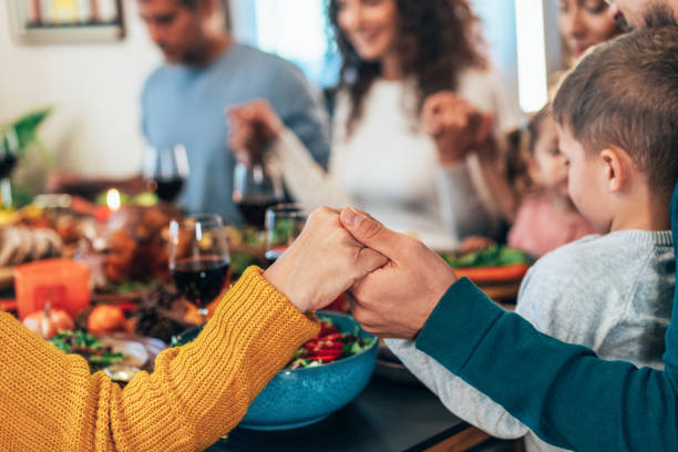 istock Family holding hands and praying on the table 2177089536