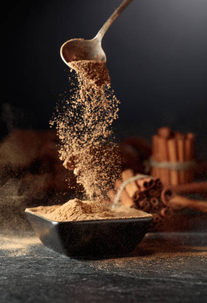 istock Cinnamon powder is poured into a black bowl. 2177090293