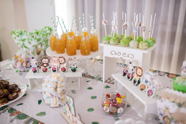 Delicious candy bar for first birthday party, colorful sweets and desserts on a table