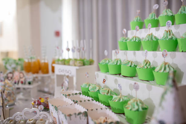 Delicious candy bar for first birthday party, colorful sweets and desserts on a table