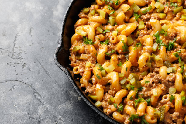 istock Cheeseburger Pasta with ground beef, melted cheese and gherkins in a iron cast pan 2177093983