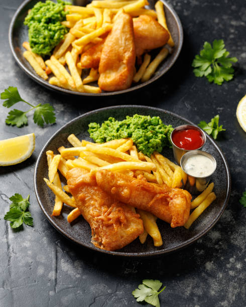 istock British Fish and chips with mashed peas, tartar and ketchup sauce. 2177094107