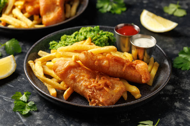 istock British Fish and chips with mashed peas, tartar and ketchup sauce. 2177094108