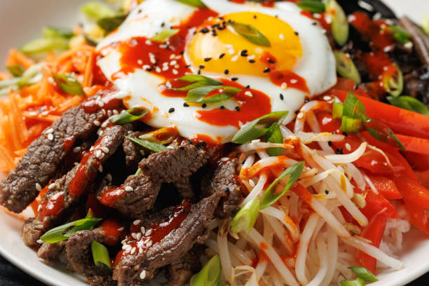 istock Traditional Korean dish Bibimbap with rice, vegetables beef and egg in a white plate 2177094109