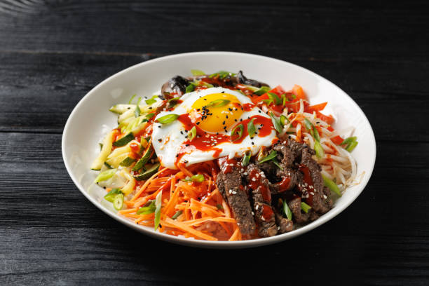 istock Traditional Korean dish Bibimbap with rice, vegetables beef and egg in a white plate 2177094110