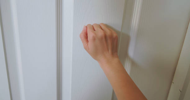 istock woman keep knocking on door 2177094706