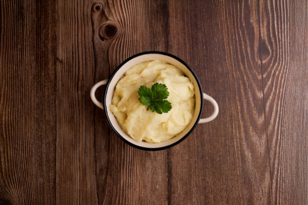 istock Freshly made bowl of mashed potatoes on a brown wooden table, top down view capturing the creamy texture and simplicity of homemade comfort food 2177098888