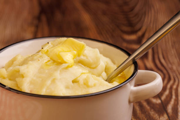 istock Comforting Mashed Potatoes with Butter Pearl on Elegant Dark Wood Table 2177098991