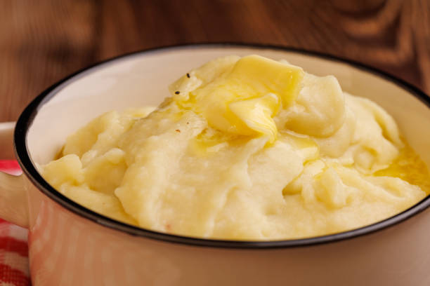 istock Creamy Mashed Potatoes with Melting Butter Pearl on Dark Wooden Table 2177099048