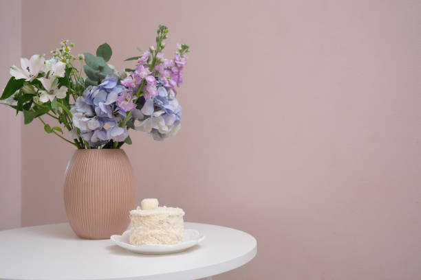 istock An Elegant Floral Arrangement Complemented by a Beautiful Cake on a Table Setting 2177100758