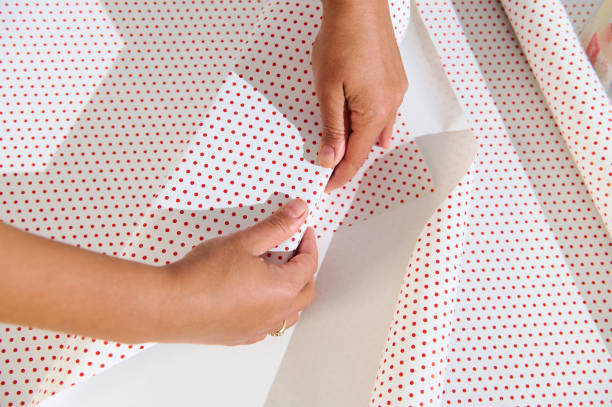 istock Hands Wrapping Gift with Polka Dot Paper 2177100872