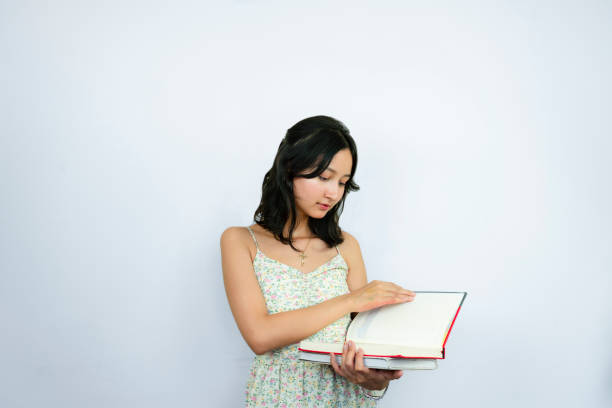 Young Asian Female Student with a Notebook for education