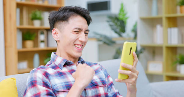 istock asian guy smartphone stock market 2177105086