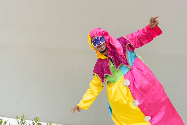 istock Person in Vibrant Harlequin Carnival Costume Striking a Playful Pose 2177107061