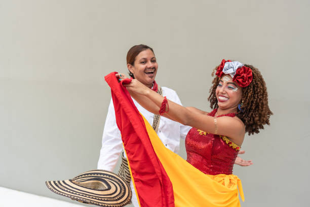 istock Two women joyfully dancing with traditional attire at carnival 2177107243