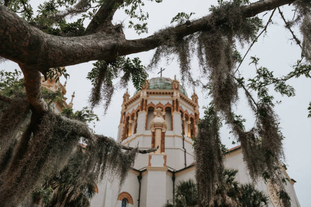 Amani’s moss through trees. Old church building. Fancy architecture, ornate Catholic Church in St Augustine, Florida