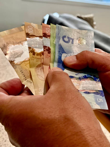 istock Hands Holding Canadian Money Closeup 2177108799