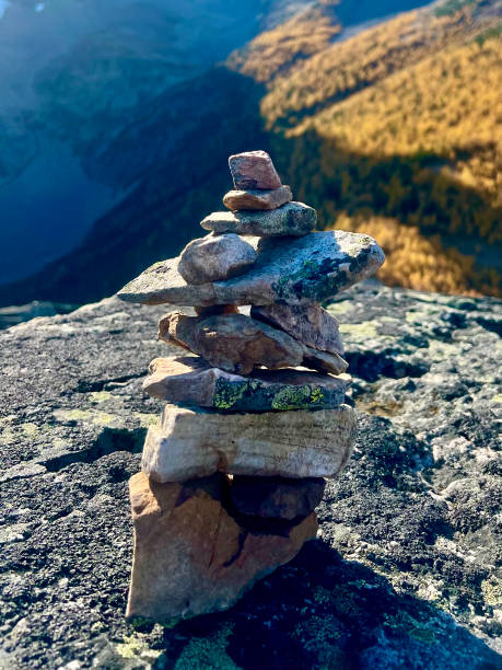 istock Inukshuk on Mountain with Larch Tree 2177108857