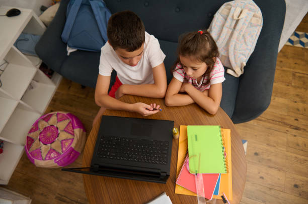 istock Children engaged in online learning at home with a laptop 2177112563