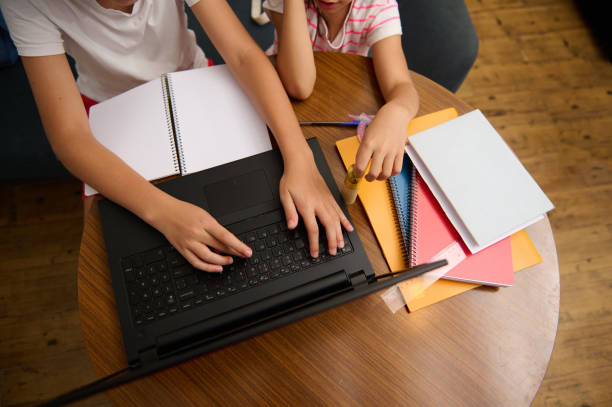 istock Children using a laptop for homework and study at home 2177112577