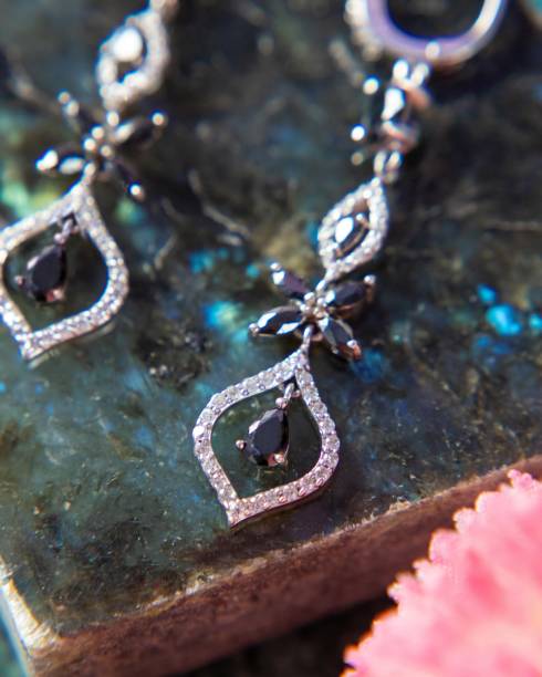istock Silver earrings with black and white diamonds are laying on a labradorite stone 2177114652