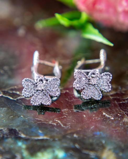 istock Pair of silver diamond earrings in butterfly shape on labradorite stone 2177114754