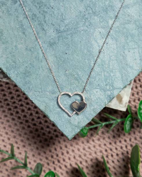 istock Silver necklace with double heart pendant on blue stone background 2177114821