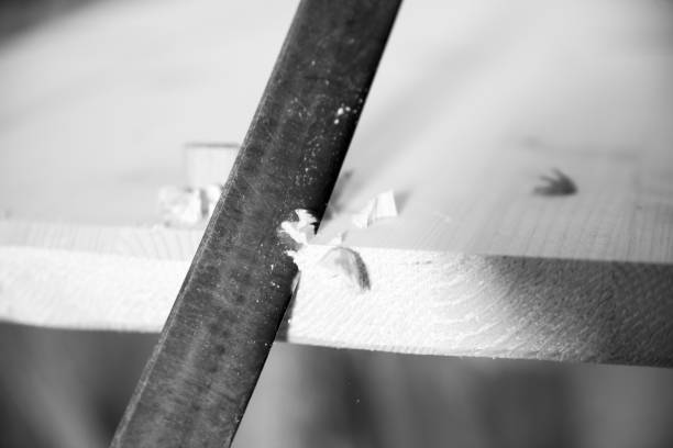 istock Black and white picture of Carpenter working wood using file in 2177115885