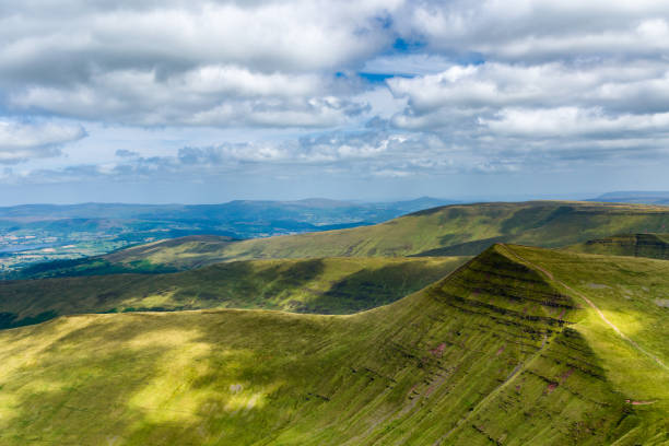 istock Hiking trail leading up a tall, green mountain 2177118345