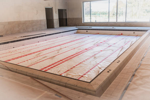 istock Indoor Swimming Pool Under Construction with Sunlight Through Windows 2177118441