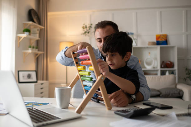 istock Fatherhood and remote business. Happy young single dad working at home while child plays next to him 2177122175