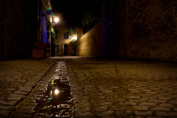 istock Old Cobblestone Alley at Night Bruges 2177122639
