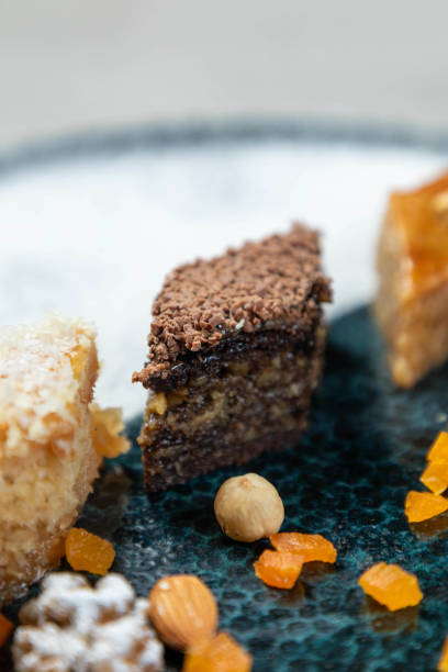 istock Chocolate covered baklava laying on a plate with assorted nuts and candied fruit 2177124795