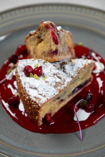 istock Delicious cranberry cake lying on berry sauce and plate 2177124825