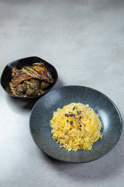 Saffron rice and eggplant being served on a modern restaurant table