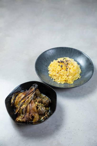istock Persian style eggplant stew with saffron rice on concrete background 2177124863